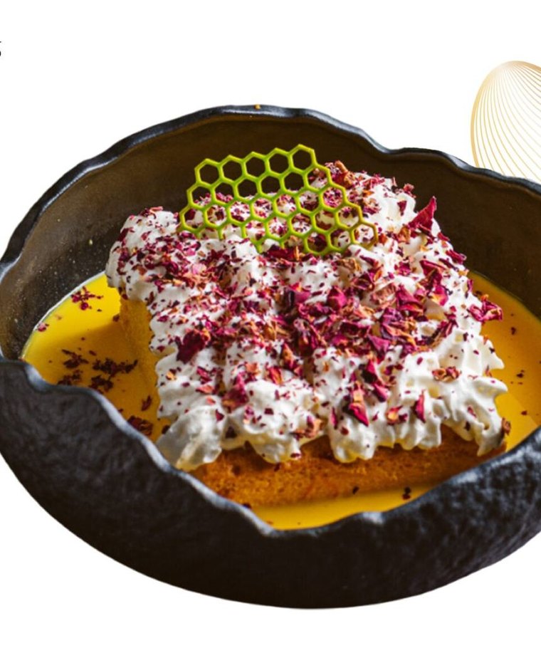 Rasmalai tres leches with whipped cream and rose petals