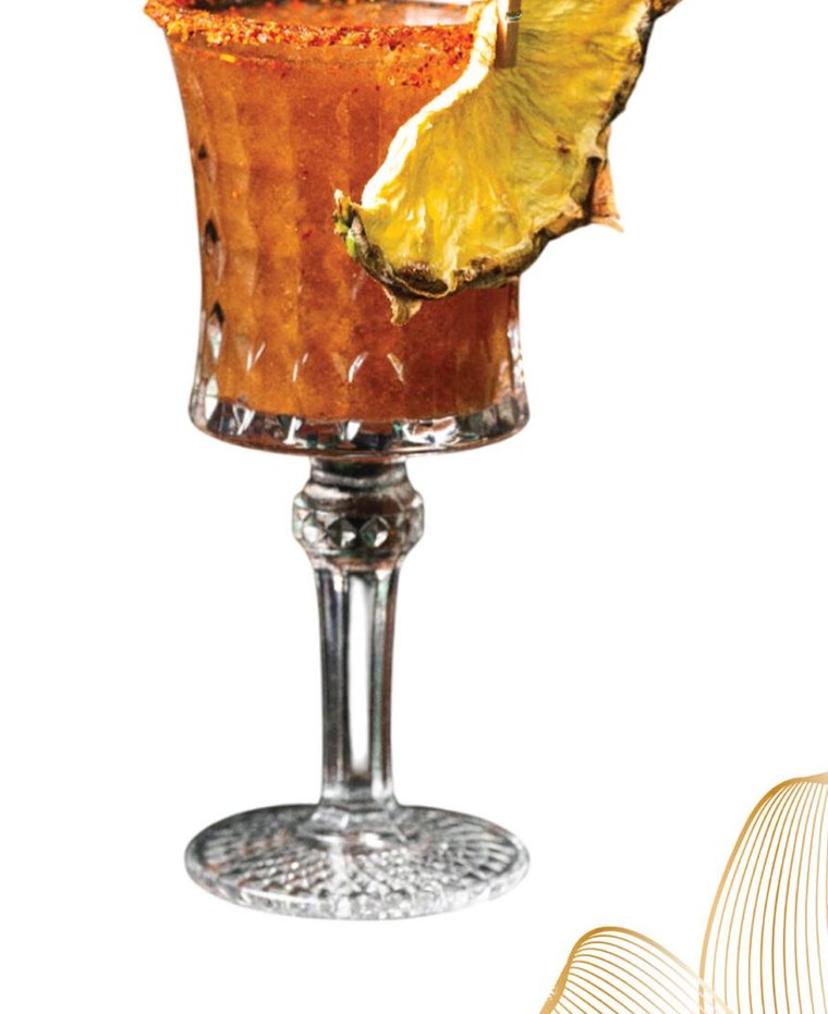 Tamarind Treasure cocktail with Tajín rim and dried pineapple